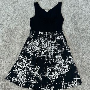Black and white dress with pockets. Ruffle and button detail on front tank top.
